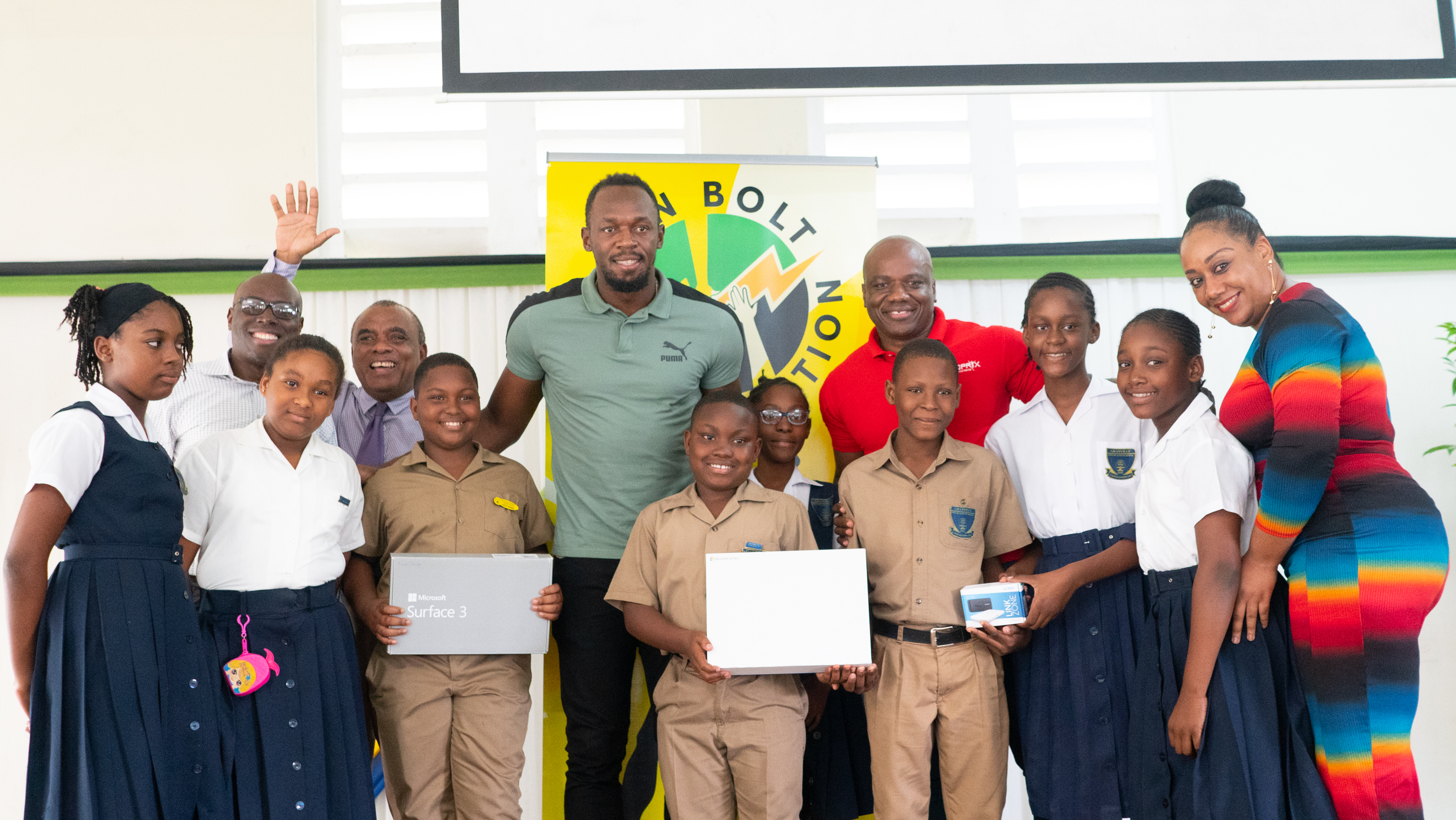 Usain Bolt Foundation refurbishes school ground and hands over computer equipment to schools in Trelawny